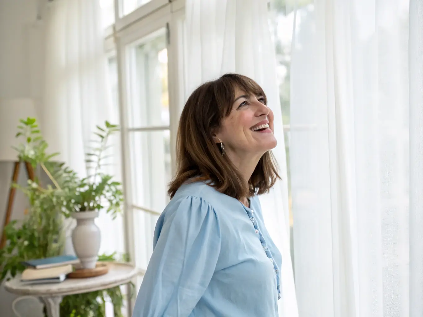 A satisfied customer smiling in their newly decorated home, showcasing Textura Home's commitment to exceptional customer service and satisfaction.